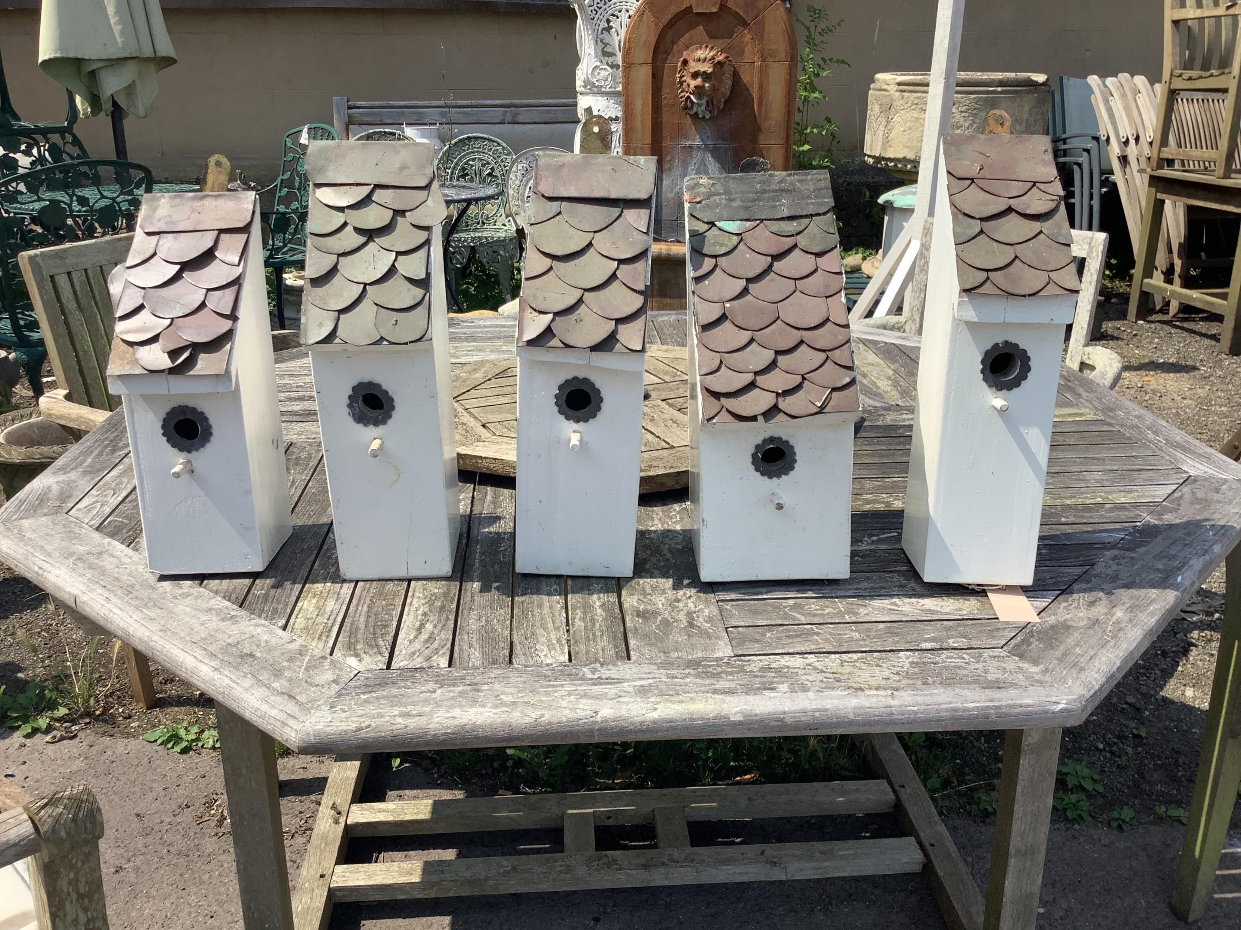 Five painted wood handmade birdboxes with shingle copper roofs, largest height 41cm. Condition - good